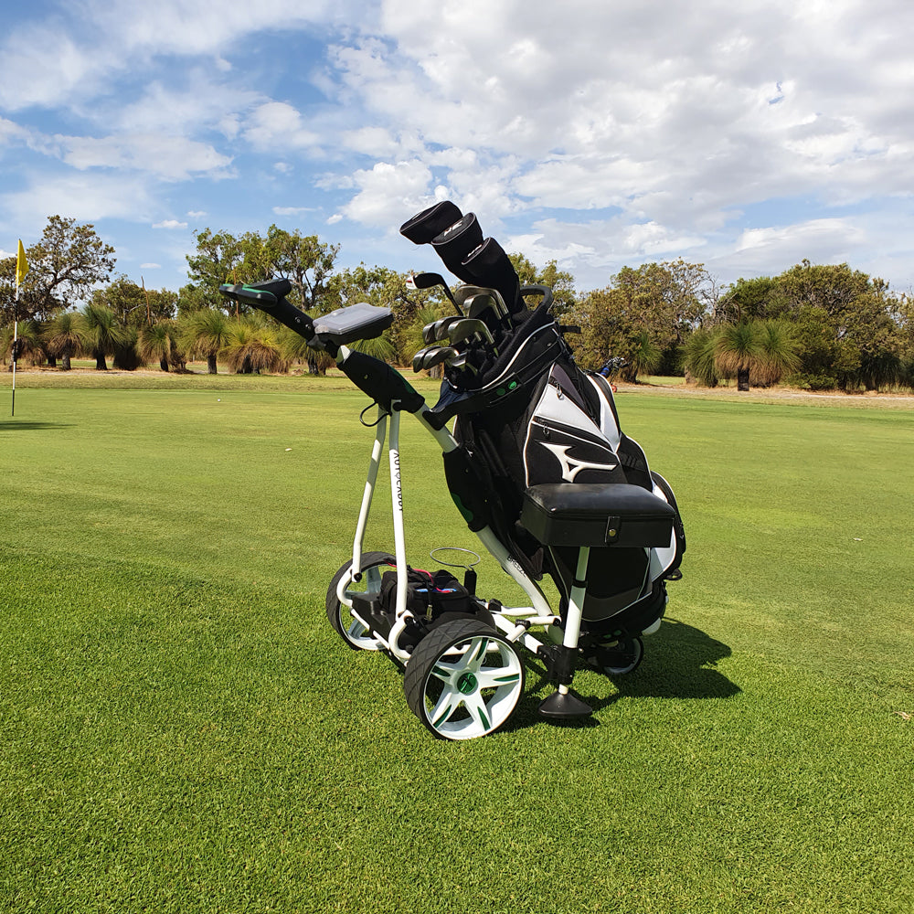 Autocaddy Lithium Golf buggy with golf clubs on a green golf course