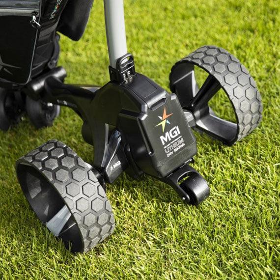 MGI electric golf buggy with lithium battery and rugged wheels on green grass, Hillside Buggies